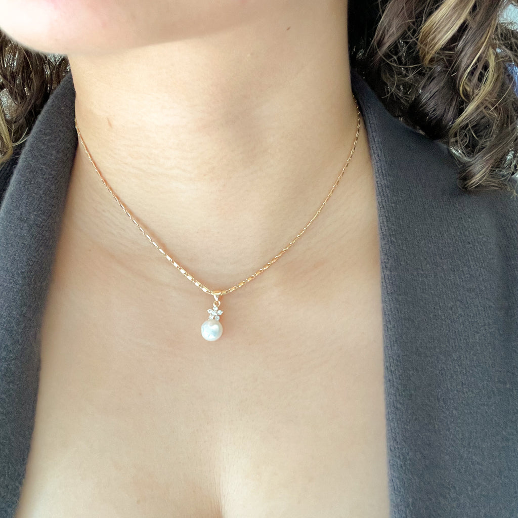 white round freshwater pearl pendant in gold chain with cubic zirconia star shaped stones on top