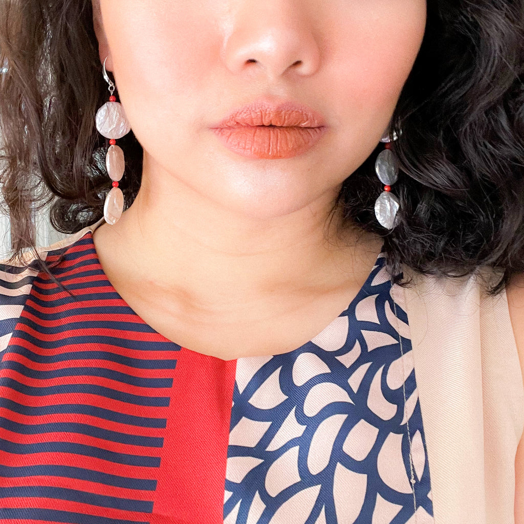 colourful dress with pearl earrings with coral accent